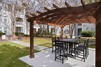 a gazebo with a table and chairs on a patio